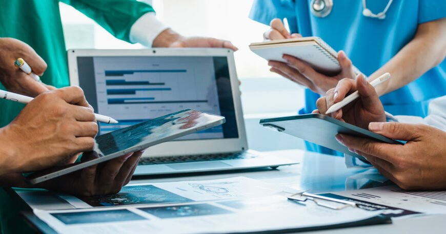 Doctors using clinical documentation software on tablets